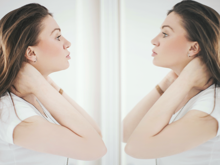 a woman looking in the mirror