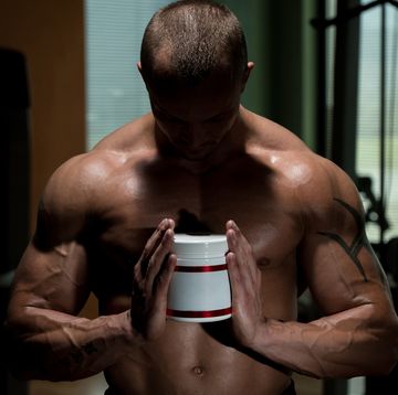 muscular handsome bodybuilder with pills and supplements beta alanine men's health