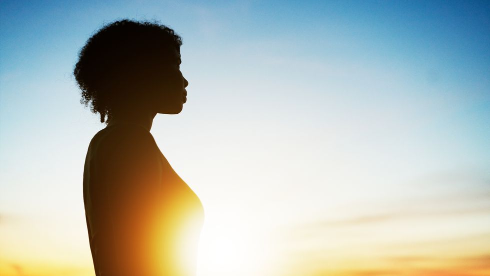 silhouette of woman at sunrise