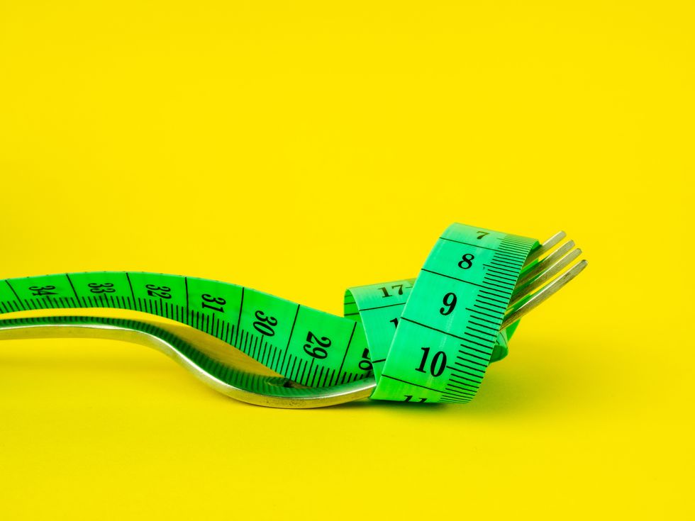 a fork with a tape measure wrapped around it