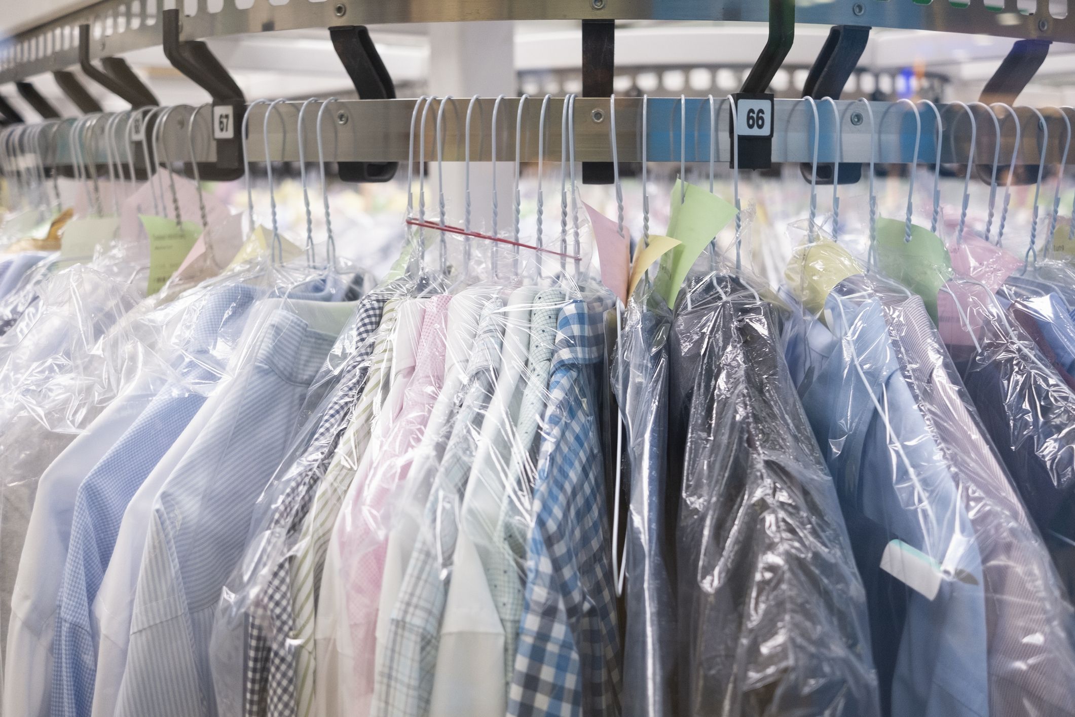 Dry cleaning shop interior. Young girl stands at reception counter and  holds clean jacket. Hanging rack with cleaned clothes. Vector flat  illustration Stock Vector Image & Art - Alamy