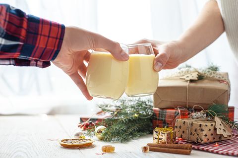 two glasses of eggnog on a white wooden table by the window christmas dessert sweet winter cocktail