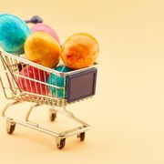 colorful easter eggs in mini shopping basket