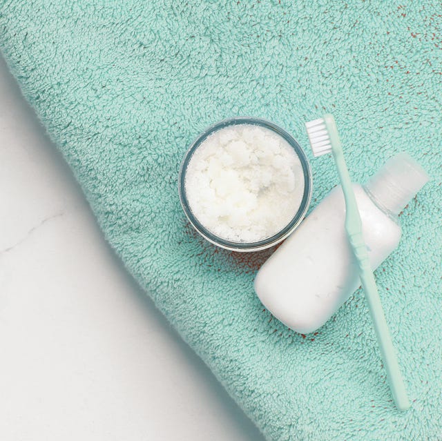 Directly Above Shot Of Toiletries With Towel On Marble In Bathroom