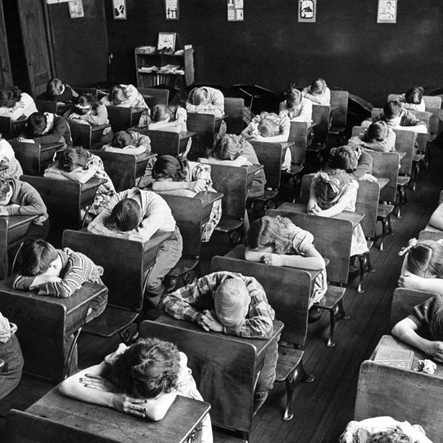Elementary school children with heads down in a classroom