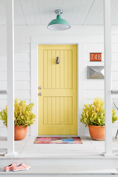 An image of a yellow doorway on a porch