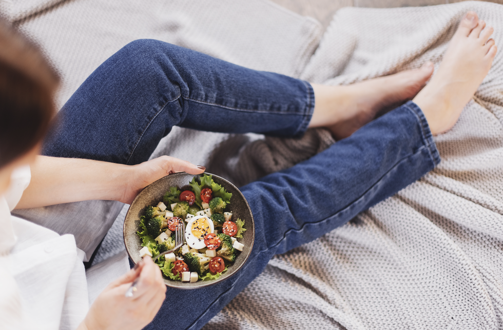 woman having salad in bed