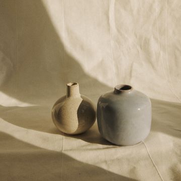 a couple of white vases on a white surface