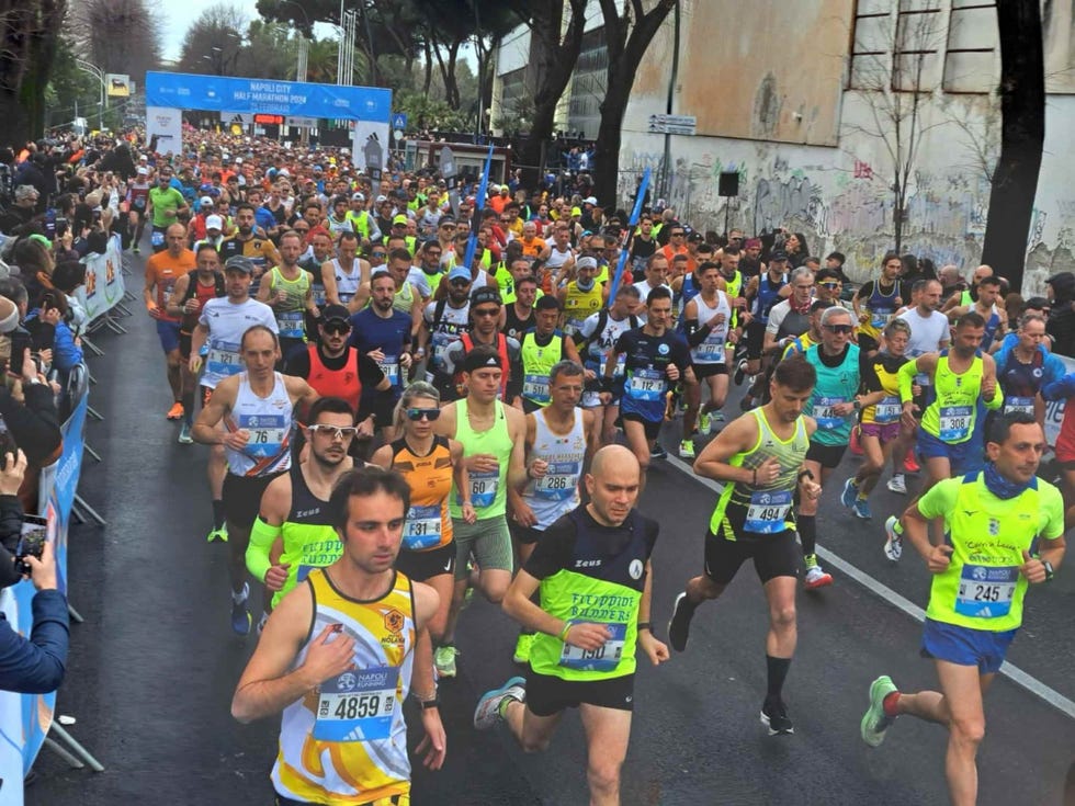 participants in a half marathon event running on a street
