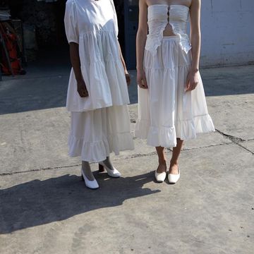 a couple of women wearing white dresses