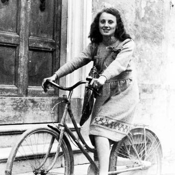 a woman in a dress on a bicycle