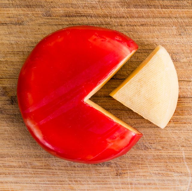 wheel of fresh gouda cheese with a red rind