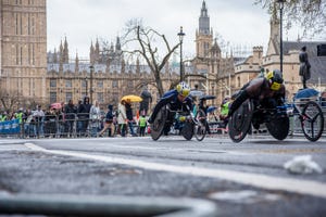 wheelchair athletes seen crossing the parliament square