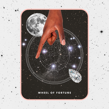 the wheel of fortune tarot card, showing a hand with dark skin reaching down into a circle in the middle of a starry sky