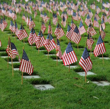 american flags mark the graves of us soldiers at los angeles national cemetery