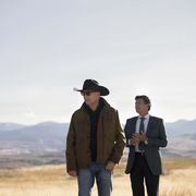 kevin costner and gil birmingham in yellowstone scene filmed in montana with mountains in background