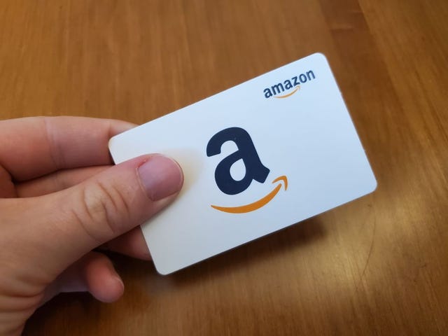 where to buy amazon gift cards, person holding a white amazon gift card