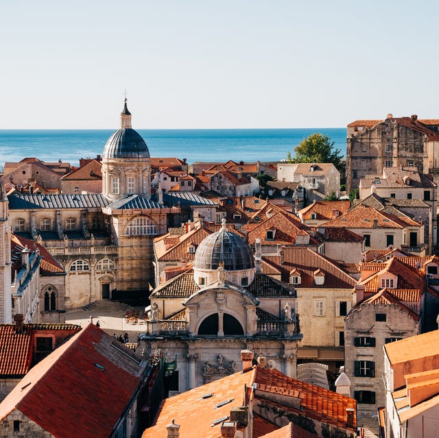 Best places to go on holiday in June a city with red roofs by the water
