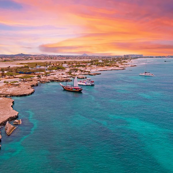 aerial from aruba island with palm beach in the caribbean sea at sunset