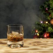 glass of whiskey in front of christmas tree