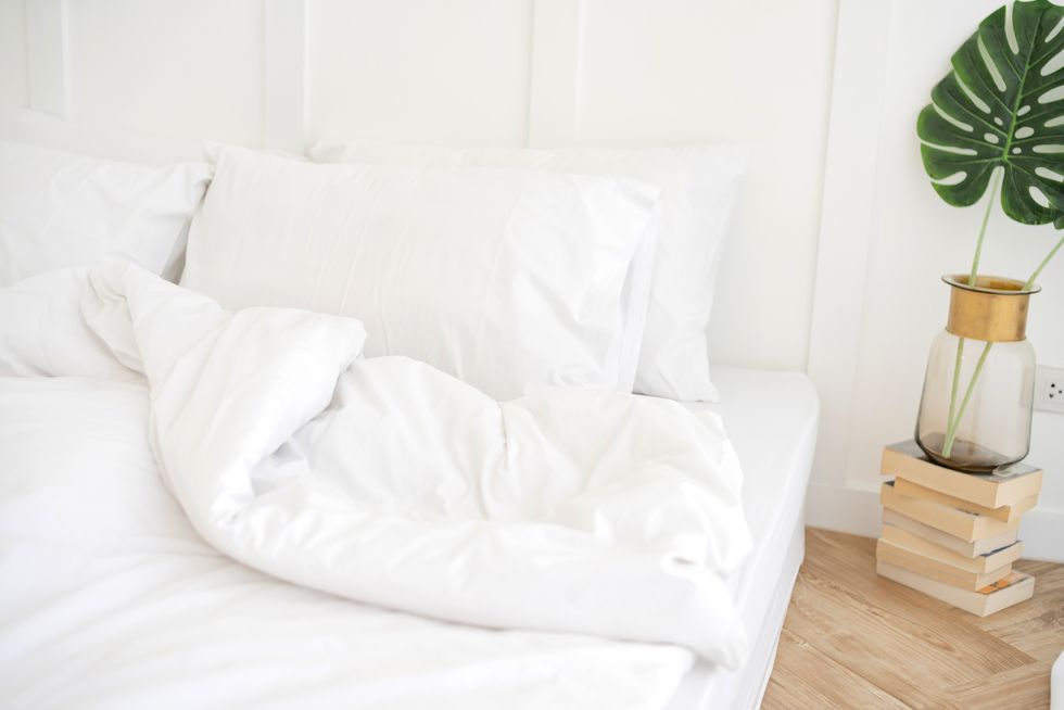 bed maid up with clean white pillows and bed sheets in beauty bedroom close up interior background