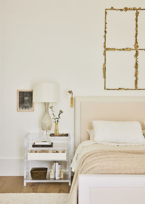 designer kristin fine’s 12 year old modern farmhouse in westport, connecticut primary bedroom bronze sculpture by tania pérez córdova, crowns a the 1818 collective bed in dedar fabric sconce garde drawing merlin james nightstand custom, antony todd lamp vintage murano bedding society limonta linens hermès blanket