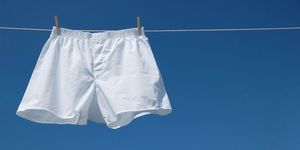 white boxer shorts clipped to clothesline against blue sky