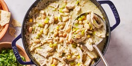 white chicken chili with cilantro, chips, sour cream and avocado