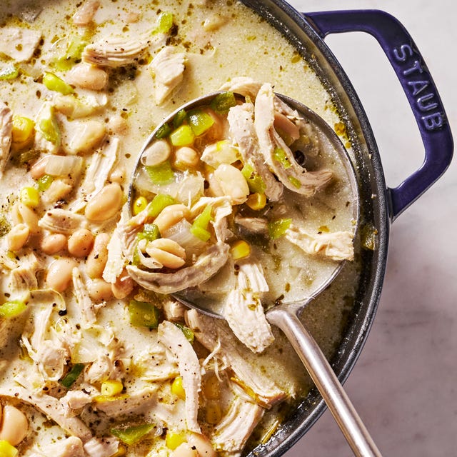 white chicken chili with cilantro, chips, sour cream and avocado