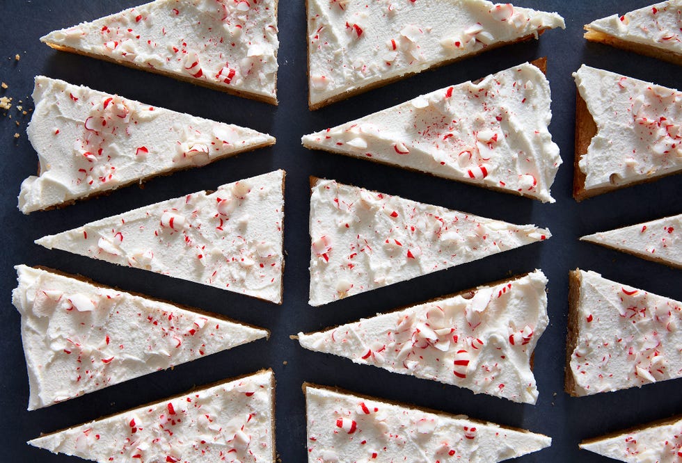 peppermint blondies cut into triangles and covered in white chocolate topped with crushed peppermint candy