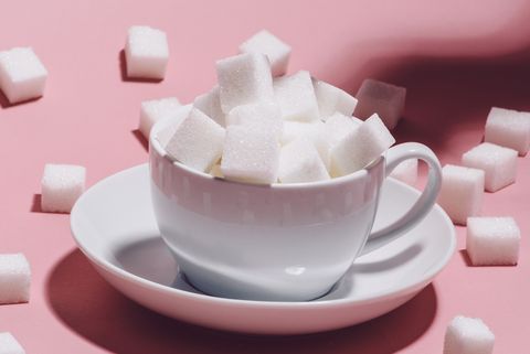 white cup full of sugar cubes