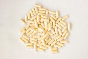 white capsules medicine pills supplement isolated on white background