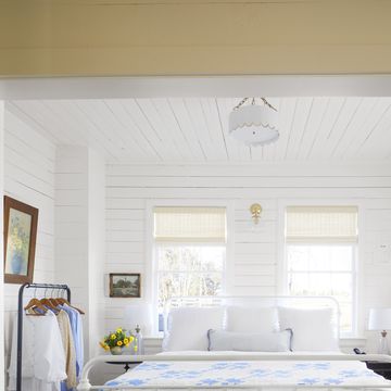 white farmhouse bedroom with blue and white quilt