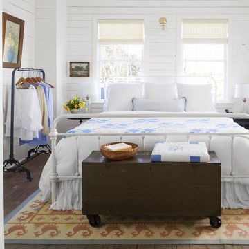 white farmhouse bedroom with blue and white quilt