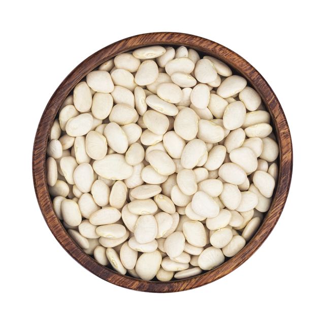 White kidney beans in wooden plate isolated on white background, top view