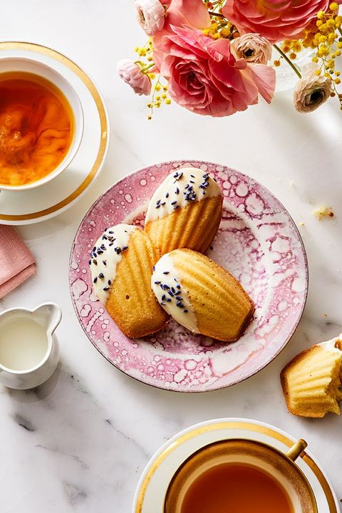 white chocolate and lavender madeleines on a pink plate