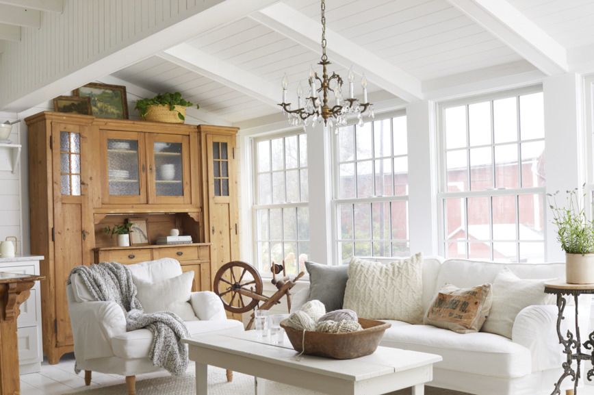 white living room with white upholstery and pine hutch