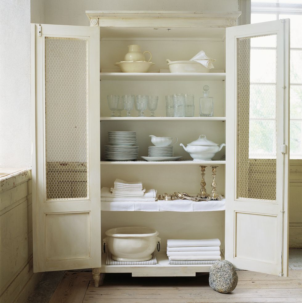 https://hips.hearstapps.com/hmg-prod/images/white-old-fashioned-cupboard-with-crockery-royalty-free-image-1701297221.jpg?crop=1.00xw:0.997xh;0,0&resize=980:*
