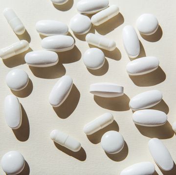 white pills and capsules on white background.