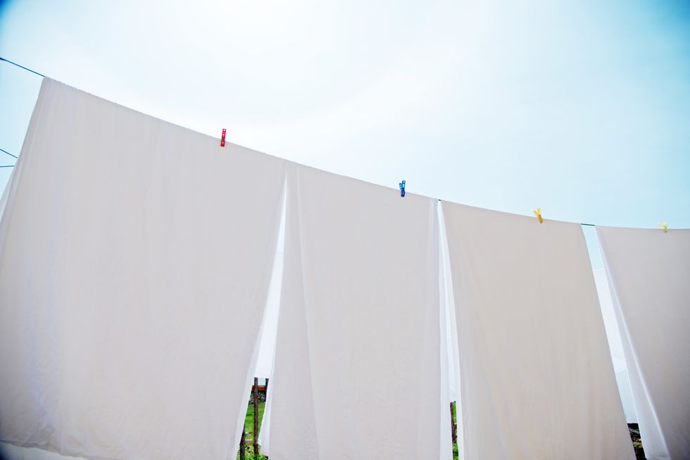 White sheets and towels hanging on clotheslines