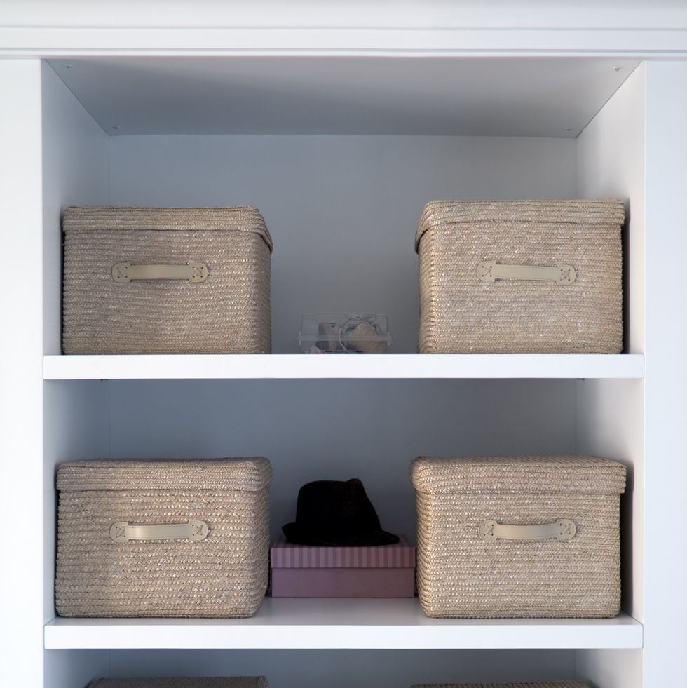 white shelved with tan boxes atop them