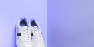 white sport sneakers shoes on the violet background fitness background