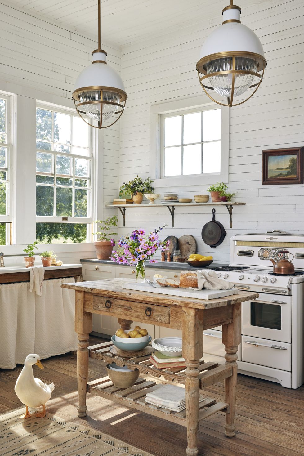 White farmhouse kitchen with shiplap walls and wood island