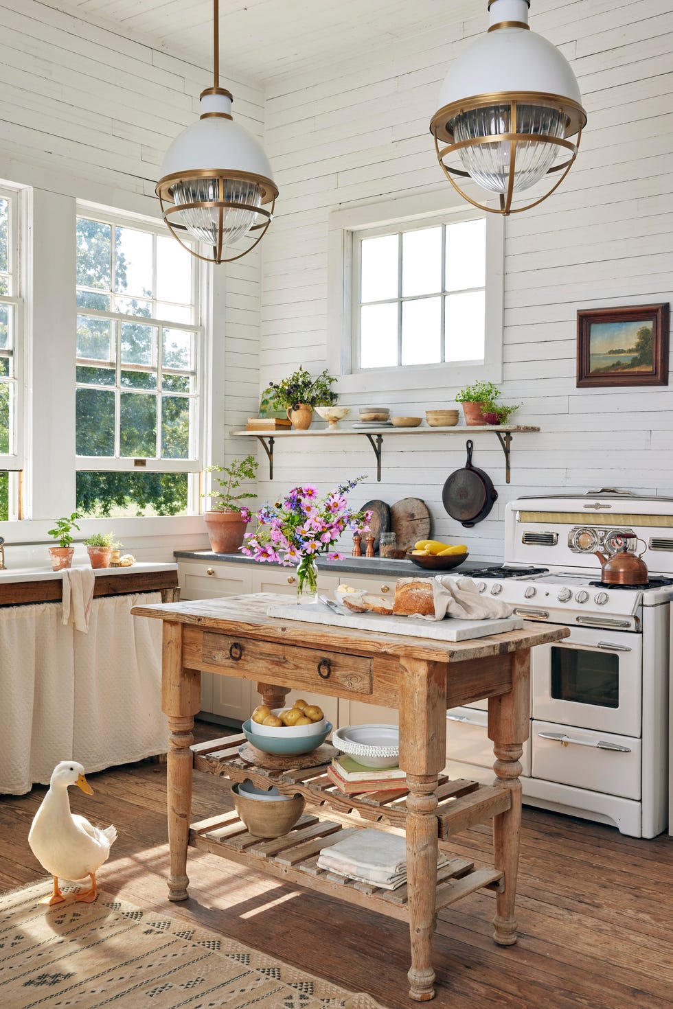 white farmhouse kitchen with shiplap walls and wood island