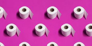 white toilet paper rolls on pink background