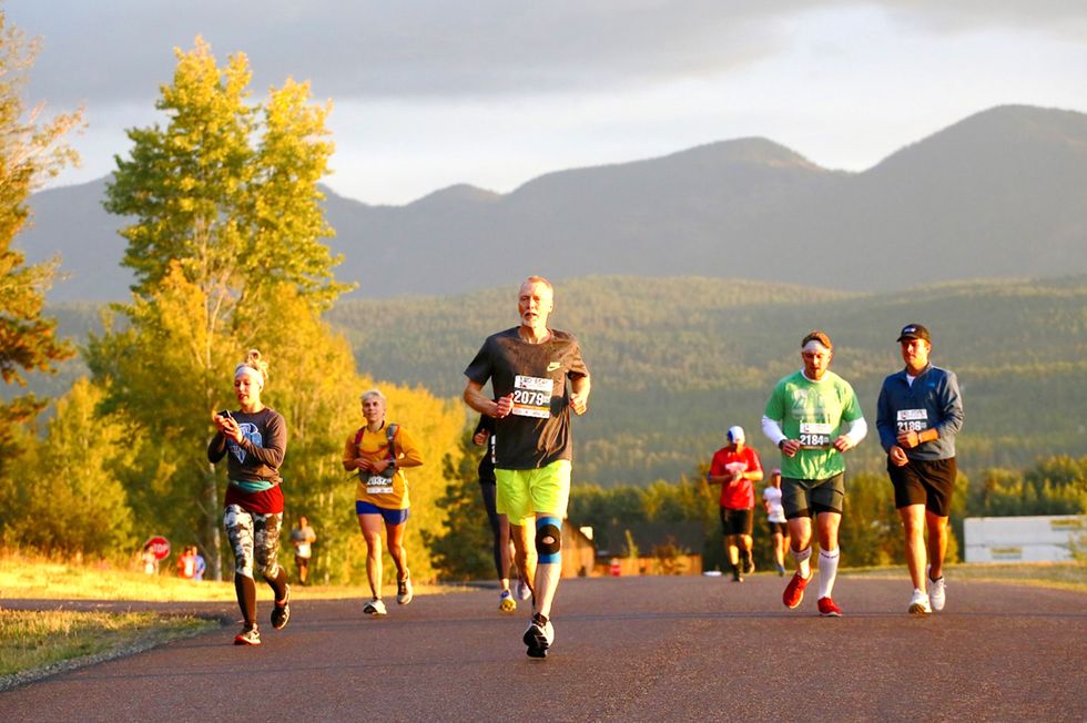 a group of people running the whitefish marathon