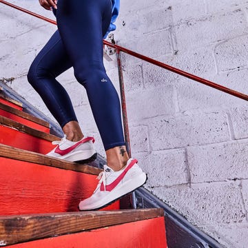 woman walking on red stairs woman walking on red stairs
