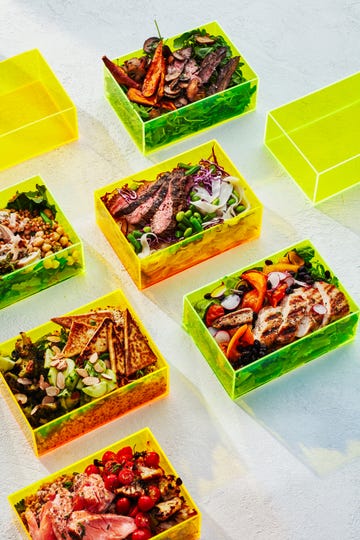 meal prepped salads in neon boxes