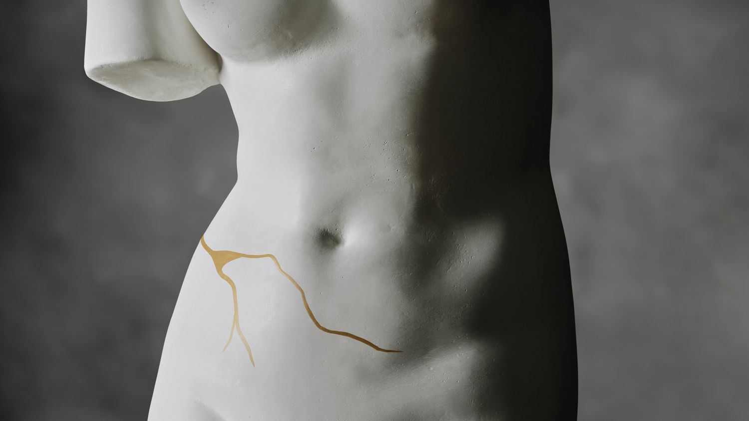 body statue with golden cracks on the body