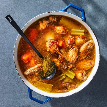 bone broth in a stock pot with chicken, carrots, and celery